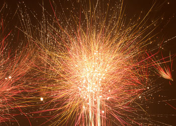 Low angle view of firework display at night