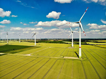 Windmill on field against sky