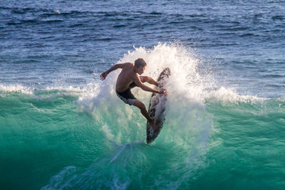 People surfing in sea