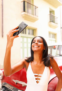 Smiling woman taking photos in havana