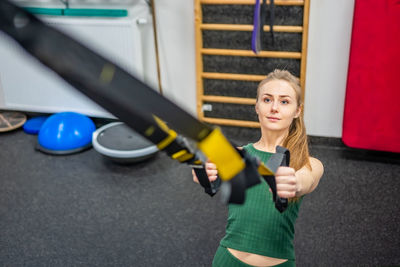 Low angle view of young woman exercising in gym