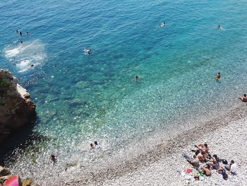 High angle view of people swimming in sea