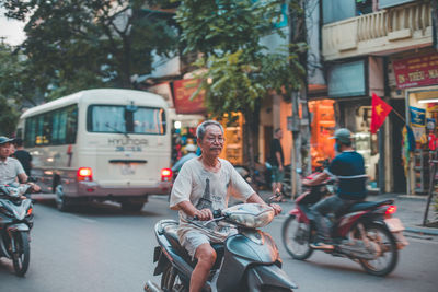 Man riding bicycle on street in city