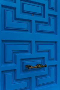 New closed modern bright blue door close up