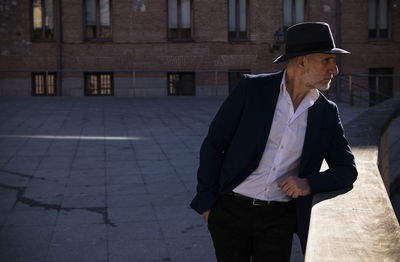 Portrait of adult man in hat and leather jacket on street. madrid, spain