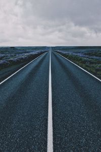 Empty road along countryside landscape