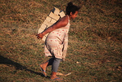 Full length of man holding hands on field