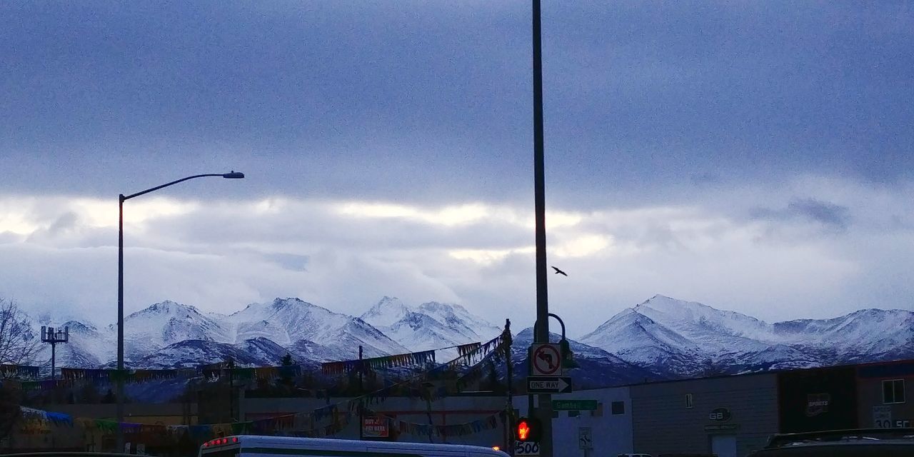 SKI LIFT AGAINST SNOWCAPPED MOUNTAINS