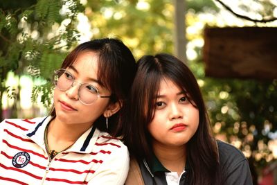 Portrait of young woman with friend