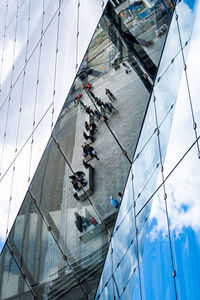 High angle view of modern glass building in city