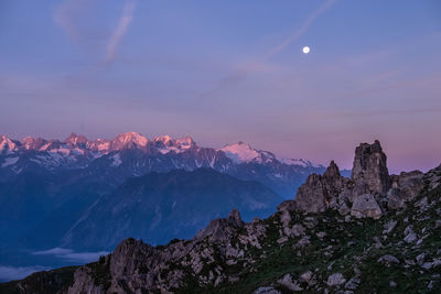 Scenic view of snowcapped mountains against sky at night