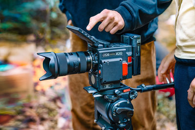 Close-up of hand holding professional movie camera