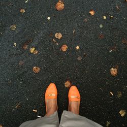 Low section of woman standing on street