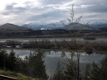 Scenic view of calm lake against mountain range