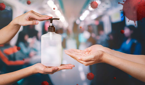 Close-up of woman hand holding bottle