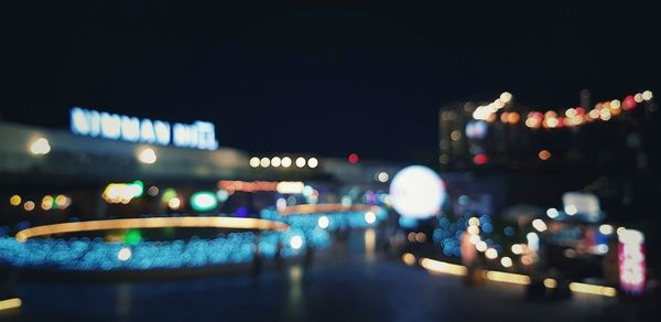 Defocused image of illuminated city at night