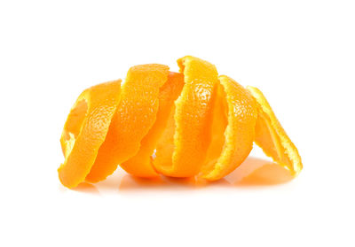 Close-up of orange fruit against white background