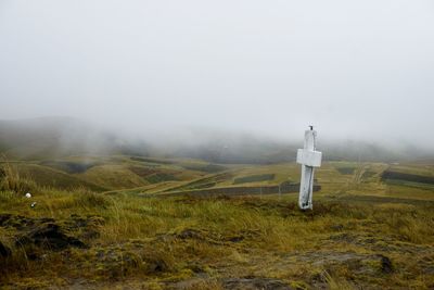 Scenic view of landscape against sky during foggy weather