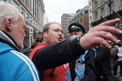 Portrait of people photographing on street in city