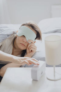 Young woman using mobile phone at home