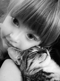 Close-up portrait of cute girl with cat