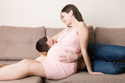 Young couple lying on sofa