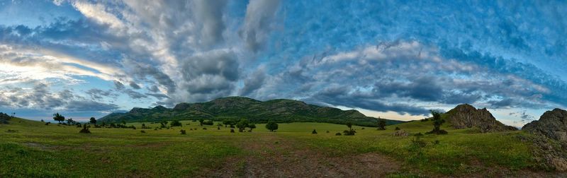 Scenic view of landscape against cloudy sky