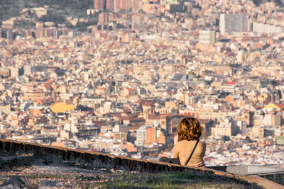 Rear view of woman looking at city buildings