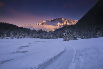 Scenic view of snow covered mountains against sky