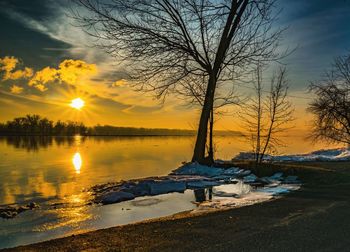 Scenic view of lake against sky during sunset