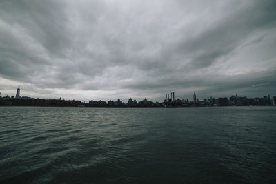 Scenic view of sea and buildings against sky