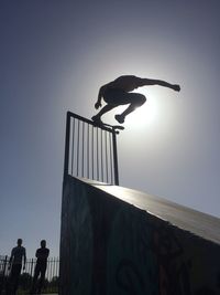 Low angle view of people against clear sky
