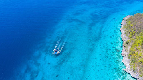 Aerial top down view of boat moving in open sea,  moalboal, oslob, cebu island, philippines.