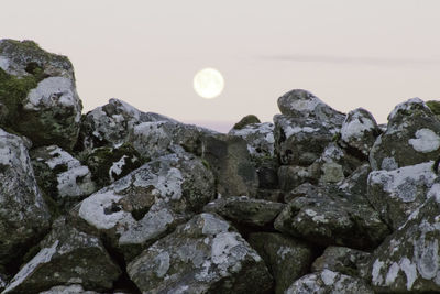 Close-up of rock formation against sky