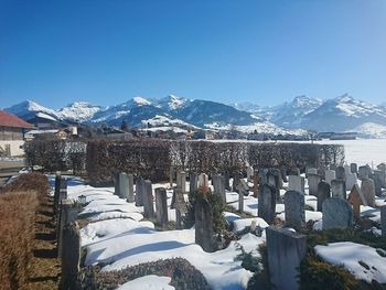 Panoramic view of snowcapped mountains against clear blue sky