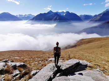 Rear view of man on mountain against sky