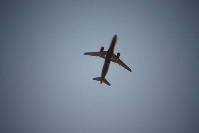 Low angle view of airplane against clear sky