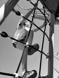 Black and white action shot of child playing on playground