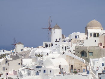 Buildings in town against clear sky