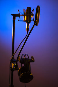 Low angle view of illuminated lamp against sky