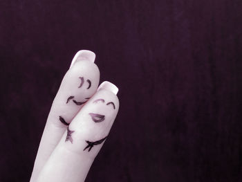 Close-up of human hand against black background
