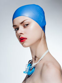 Portrait of young woman against white background