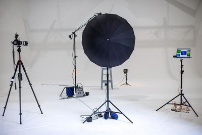 Commercial photography session using a cyclorama and studio lights shooting tethered to a computer.