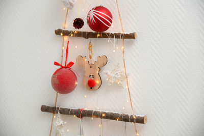 Handmade wooden christmas tree with toys hanging on the wall