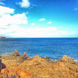 Scenic view of sea against cloudy sky