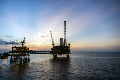 Oil production platform during sunset at offshore oil field