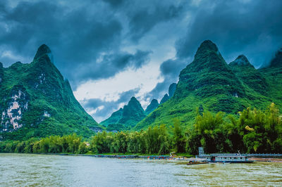 Scenic view of lake against cloudy sky