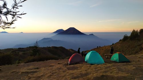 Scenic view of tent against sky during sunset