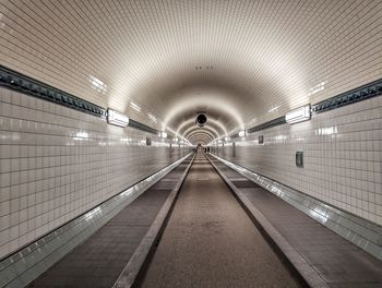 Rear view of man walking in tunnel, elbtunnel hamburg 