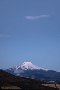 Scenic view of snowcapped mountains against blue sky